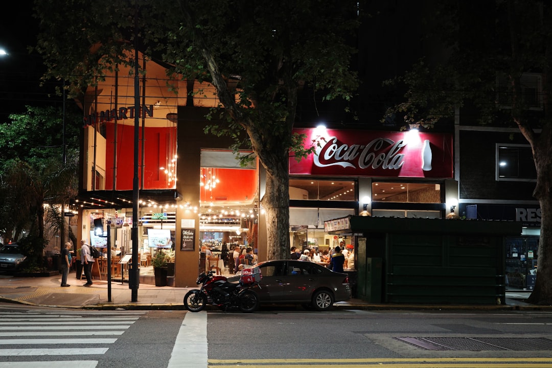 A street scene at night with a coca-cola sign
