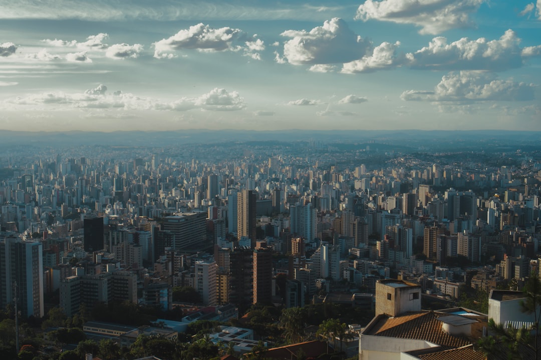 Vast cityscape stretches towards the horizon under a cloudy sky.