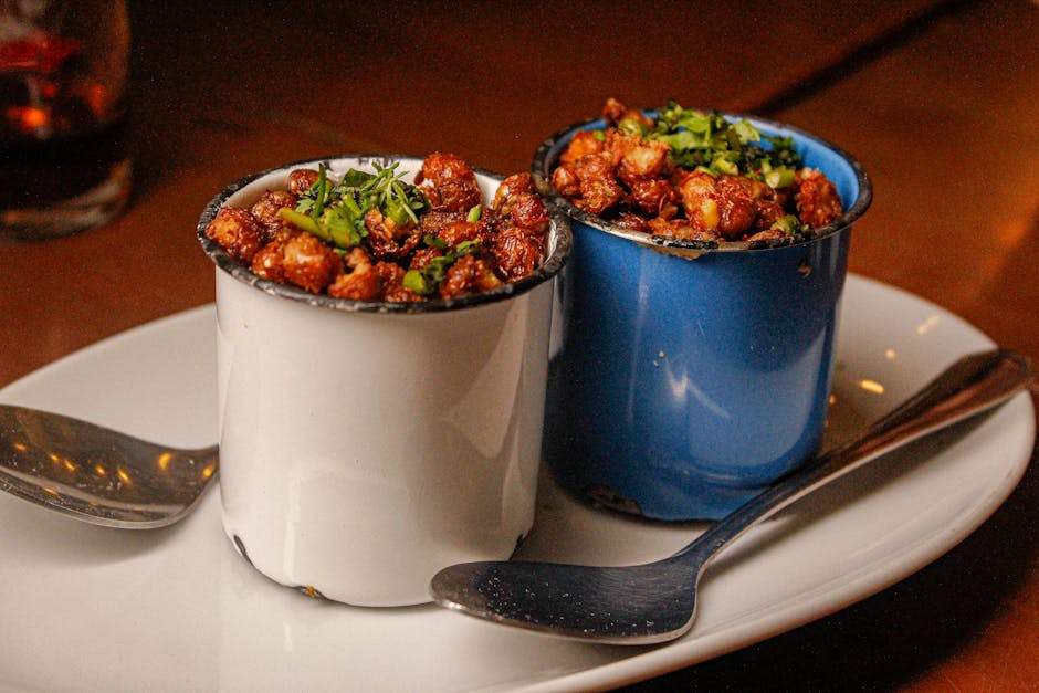 Delicious Brazilian snacks served in colorful cups on a plate, perfect for a culinary experience.