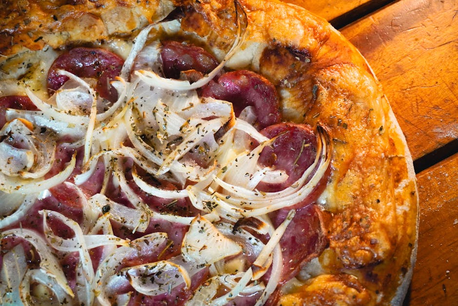 Close-up of a rustic pizza topped with fresh onions and salami, perfect for food enthusiasts.