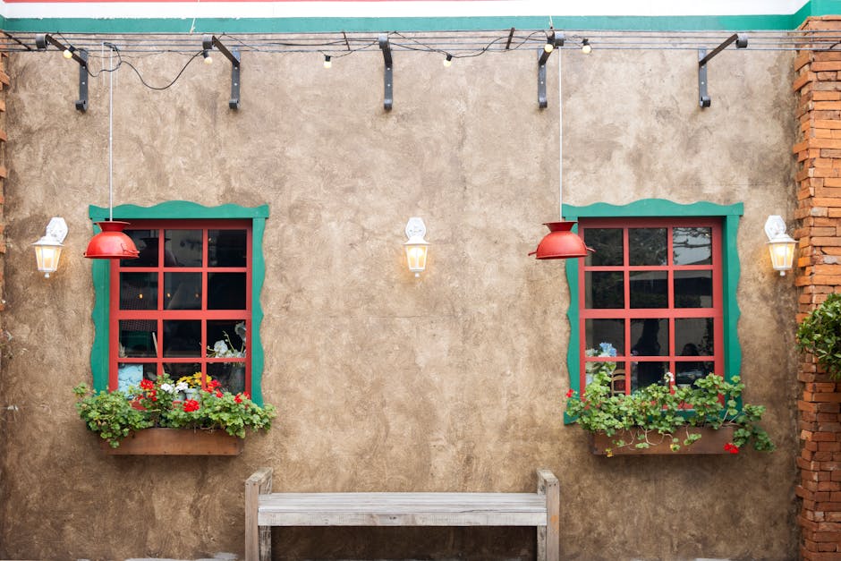 Rustic wall with red-framed windows and flower boxes in Rio Grande do Sul, Brazil.