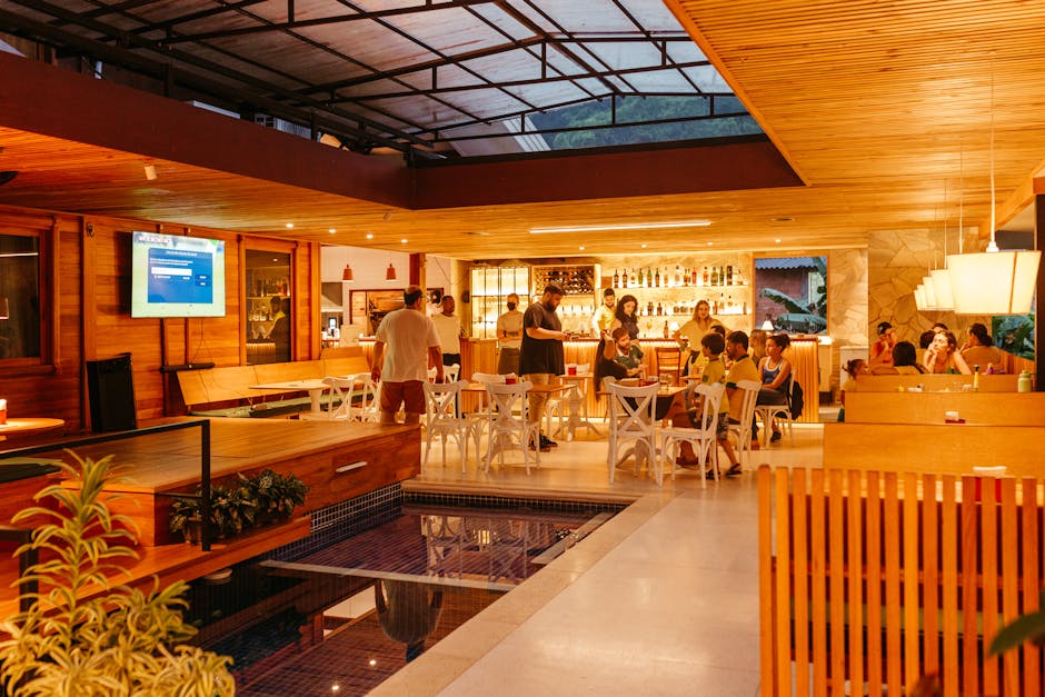 Interior of a bustling restaurant bar with people enjoying a warm evening.