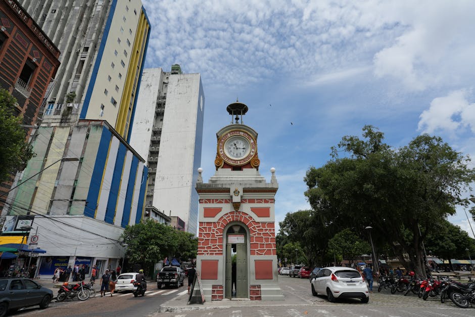 Historic clock tower Relógio Municipal amidst cityscape in Manaus, Brazil.