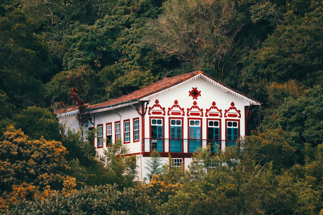 Beautiful, colorful house nestled in lush greenery.