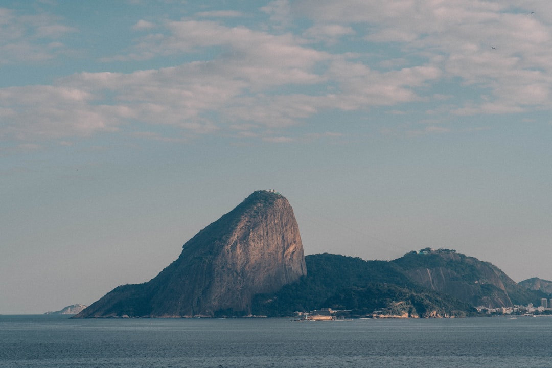 Sugarloaf mountain rises above the ocean.
