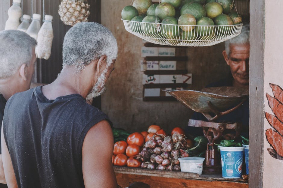 A lively street market with elderly vendors selling fresh fruits and vegetables.