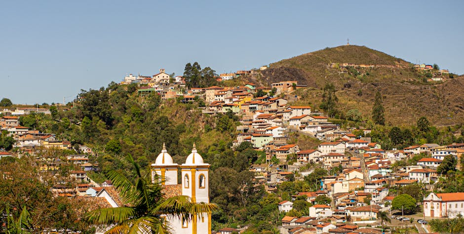 Picturesque landscape of hillside villages in Ouro Preto, Brazil showcasing lush greenery and charming architecture.