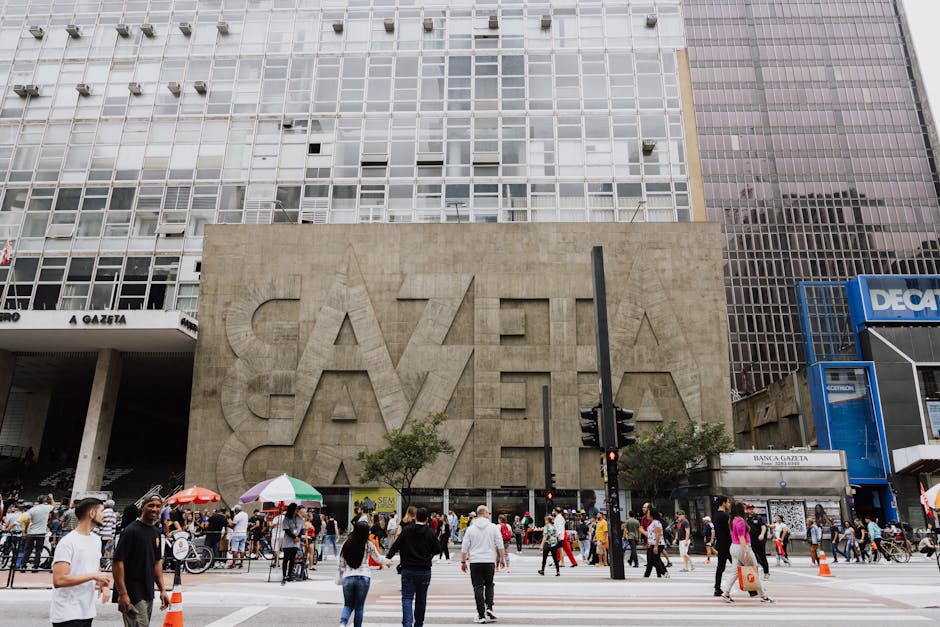 Crowded street view in front of Gazeta building on Paulista Avenue, São Paulo.