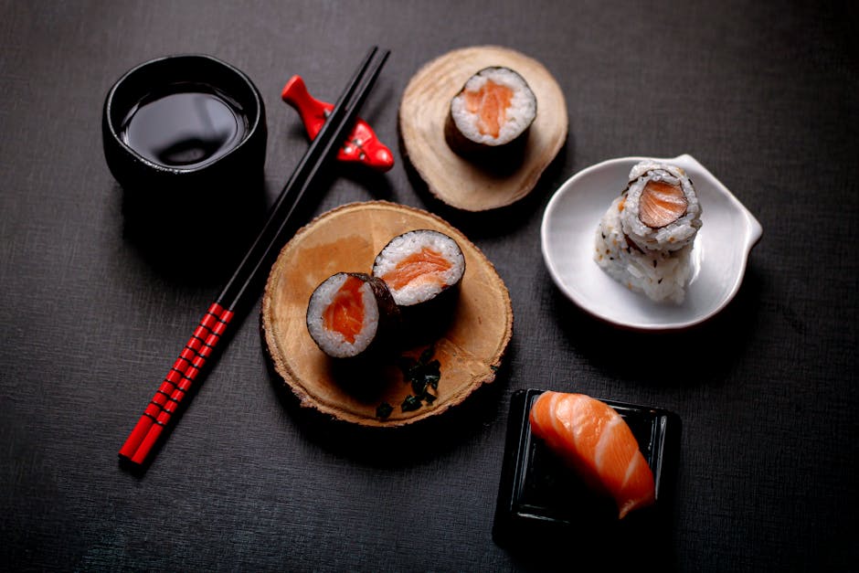 Stylish overhead shot of salmon sushi with soy sauce and chopsticks, perfect for culinary use.