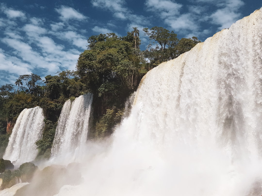 photo of waterfalls across blue sky