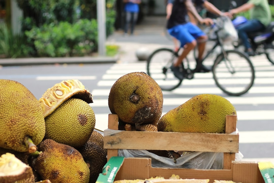 A box of fruit sitting on the side of a road