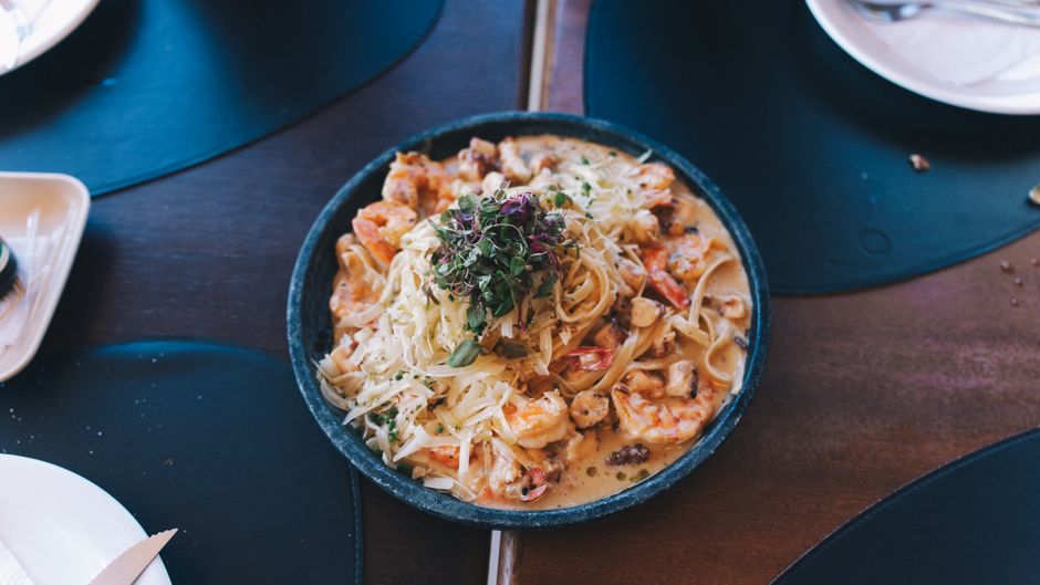 A close-up of a mouthwatering seafood pasta dish with shrimps, garnished elegantly.