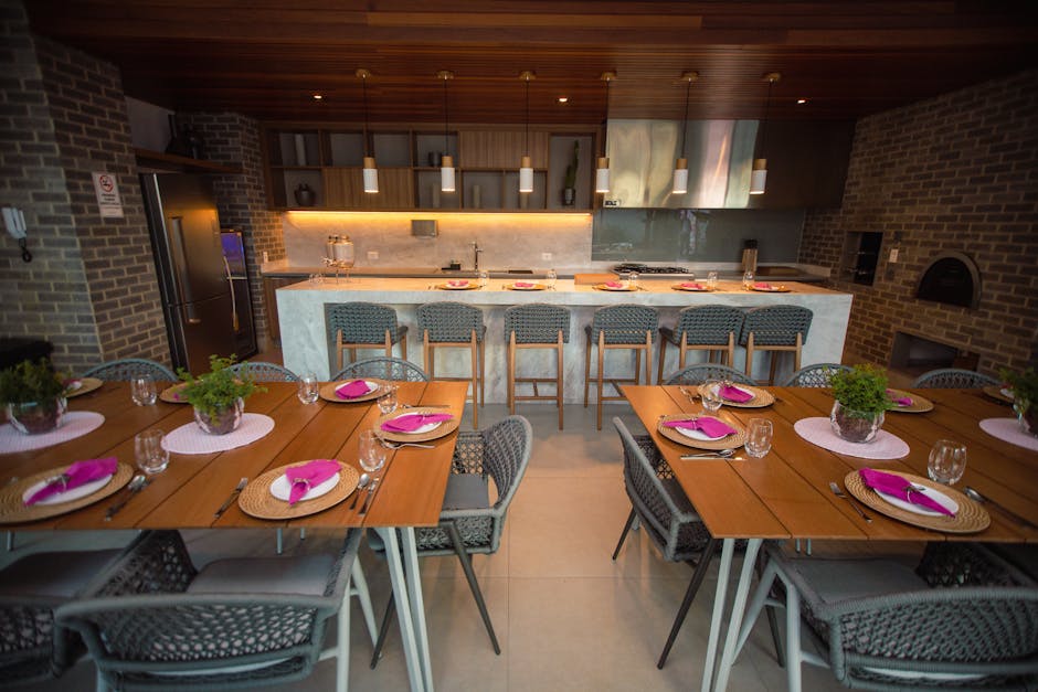 Modern dining area with stylish furniture and dinner setup, ready for guests.
