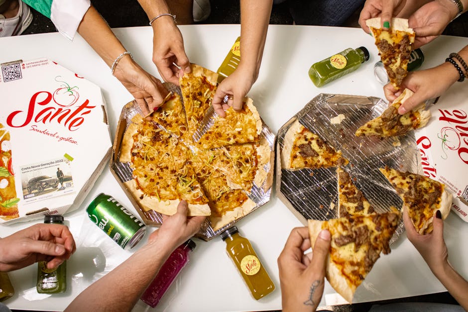 Top view of friends sharing pizza slices with drinks, perfect for a casual dining theme.