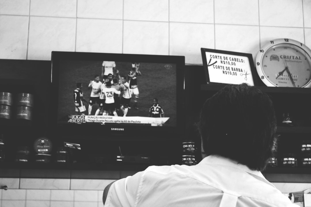 a person watching a tv in a kitchen