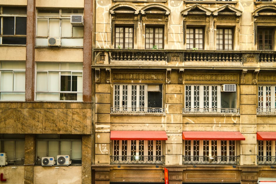 A detailed view of historic architecture with ornate windows and red awnings in São Paulo, Brazil.