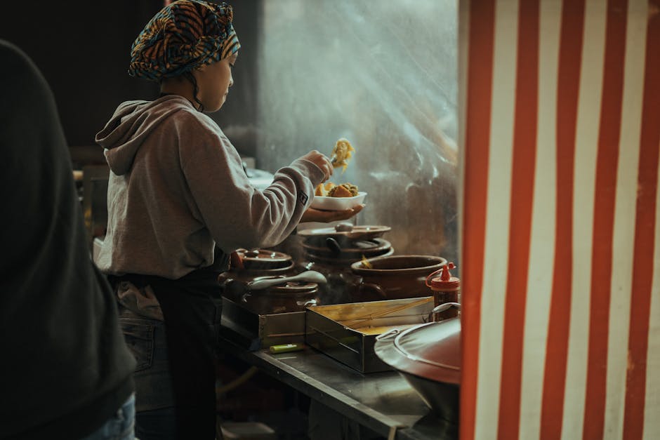 A woman in a headscarf prepares a noodle dish in a cozy São Paulo kitchen.
