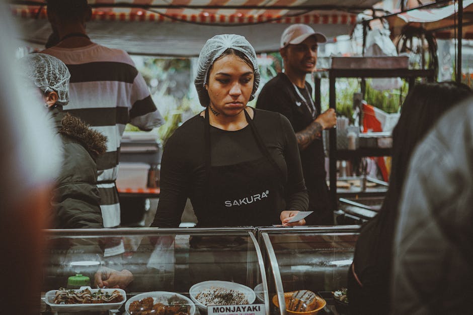 Street food vendor in a bustling São Paulo market preparing traditional dishes.