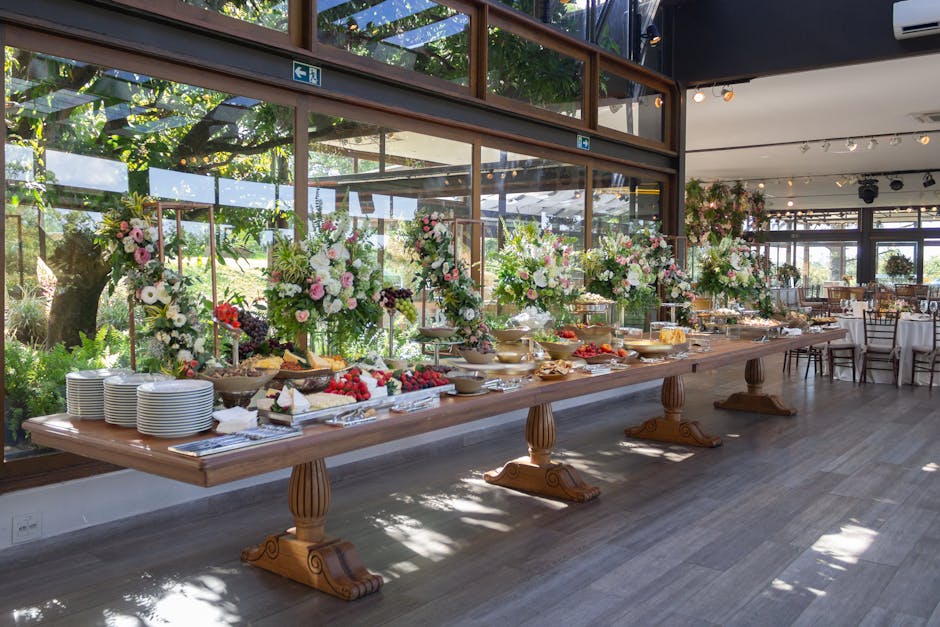An elegant indoor buffet in São Paulo featuring floral arrangements and assorted foods for a special event.