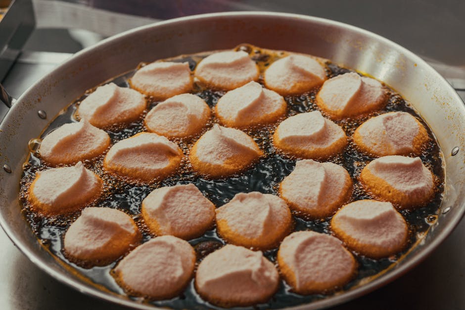 Close-up of pastries frying in oil, highlighting São Paulo's culinary scene.