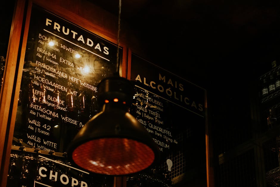 Warm bar interior with a menu board and pendant light in São Paulo, Brazil.