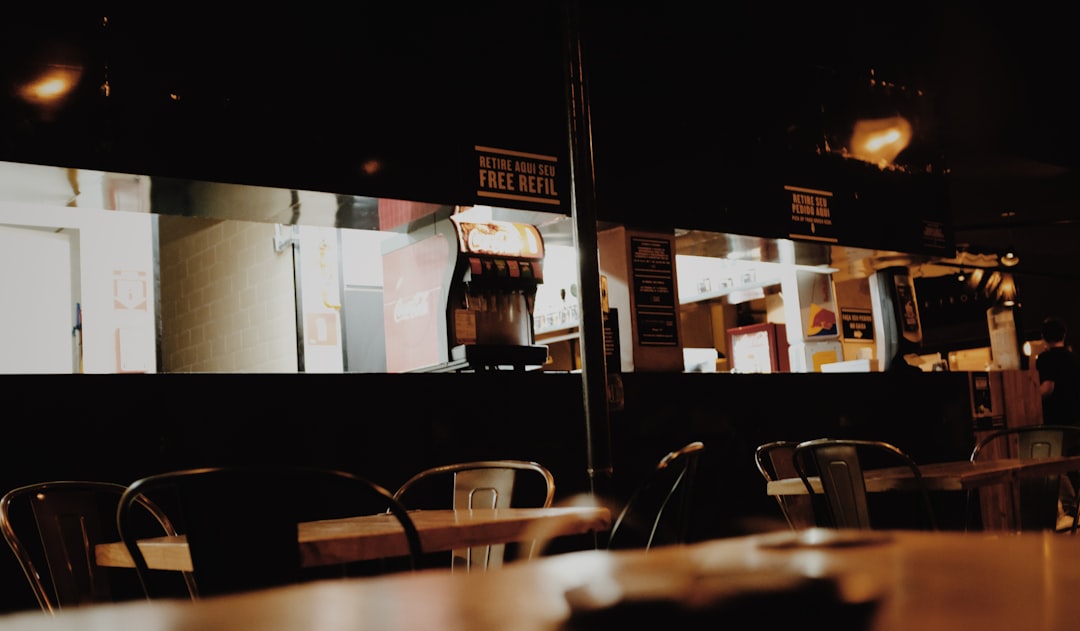 a restaurant with tables and chairs in the dark
