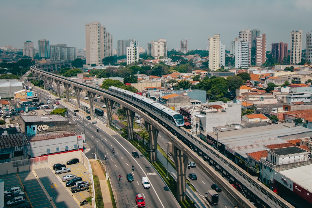 an aerial view of a city with a train on the tracks