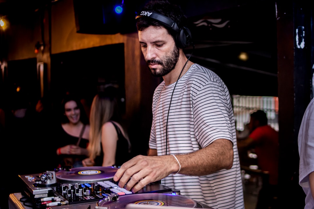 a man that is standing up with some dj's
